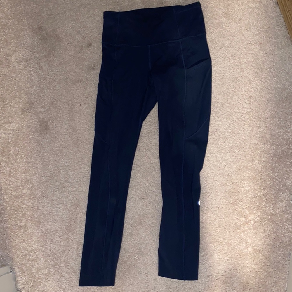 This is Navy LuluLemon leggings. Pockets on the side. Come up on the calf.